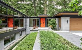 Large expanses of glass (windows, doors, etc) often appear in modern house plans and help to aid in energy efficiency as well as indoor/outdoor flow. The Last House A Modern Glass Bungalow By David Small Designs