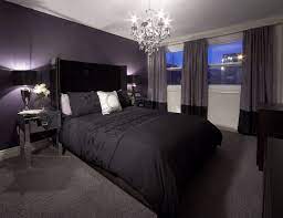 Shared purple girls' room features walls painted purple lined with a pair of white tufted twin beds dressed in purple bedding and pillows flanking a three drawer dresser with ring pulls and a crystal baluster lamp placed beneath a lattice mirror illuminated by a french candle chandelier. Pin By Sam Bulmer On Lux Bedrooms Purple Bedrooms Bedroom Design Purple Bedroom Design