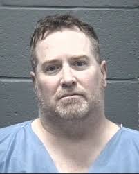 Suspect arrested after allegedly pointing gun at victims outside house