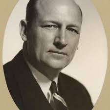 Rudolph K. Froker with a milk vending machine