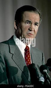 Republican presidential candidate Patrick Buchanan, left, shows off a  anti-Bush T-shirt he received after arriving for a small rally in Miami,  Florida, Sunday, Feb. 24, 1992. Buchanan then left for Jacksonville,  Florida. (