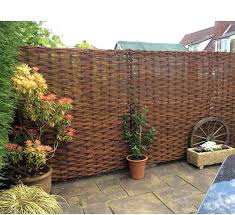 Next you want to unroll your garden fencing and attach it to the hooks. Putting Up Willow Hurdle