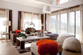 Kelly green and pale blues are cooler colors that contrast nicely with the warmth of brown and energize this family room. Learn What Colors Go With Brown And How To Use Them