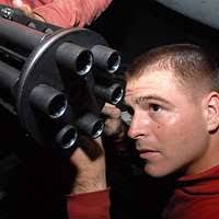 Aviation Ordnanceman 2nd Class Hunter Owens, from Baton Rouge, La.,  reinstalls an M-61A1 20mm Gatling gun in the gun bay of an F/A-18C Hornet  assigned to the