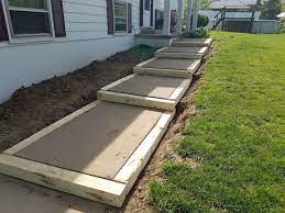 How to maintain concrete walkways. Building A Side Walk Building A Walk On A Slope Diy Sidewalk Using Salvaged Items To Frame A Walk Outdoor Stairs Landscape Stairs Sidewalk Landscaping