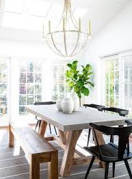 Black Wooden Chairs At A Wood And Concrete Trestle Dining Table In A Modern Farmhouse Dining Room Concrete Dining Table Transitional Dining Room Dining Table