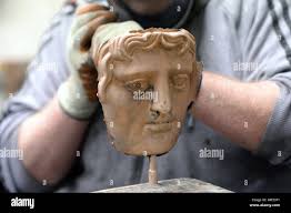 A BAFTA mask is made at New Pro Foundries in West Drayton, Middlesex, ahead  the ceremony later this month Stock Photo