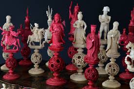 A chinese antique ivory chess set, in natural and red staining. Early 19th Century Chinese Ivory Napoleon Chess Set