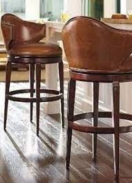 With real leather covering the seating area—where it matters most—this piece has skillfully matched leather elsewhere, so you won't get hemmed in by the price. Jazz Up Your Kitchen With Trendy Kitchen Bar Stools Kitchen Decor Tips Low Back Bar Stools Leather Bar Stools Designer Bar Stools