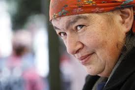 With flowers and chair, seller loves motion at 100-year-old stand