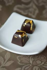 Take a sheet of edible gold leaf, and cut away a small square of gold leaf with a. Artisan Chocolates