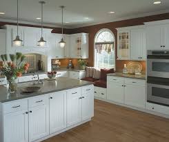 Meeting the challenge of a dramatic setting, yet making a wonderful space for relaxation, simsbury rustic beadboard style cabinets have the texture and interest to bring wood beams and fieldstone into a welcome embrace. Homecrest Kitchens