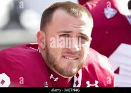 Kent State Golden Flash quarterback Spencer Keith (11) trying to get up  after the sack during the NCAA football game between the Kent State Golden  Flash and the Temple Owls at Lincoln