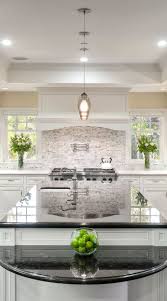 The white subway backsplash choice with white cabinets, black kitchen countertop pop up the pattern of the cooker hood's backsplash tile. White Cabinets With Black Countertops Backsplash Decorkeun