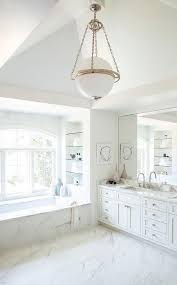 A black cistern wall backs a modern white toilet, and a black shelving unit holds a selection of grey towels. White And Black Bathroom With Alcove Shelves Transitional Bathroom