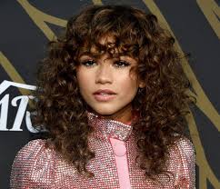 The hair ends are made slightly messy giving it a this is a brunette hairstyle with front bangs. Medium Length Curly Hair With Unfussy Bangs Hairstyle Archives