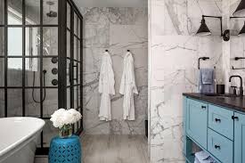 A small bathroom with a shower separate with white long tiles, a printed tile floor, a potted plant and a white vanity a small bathroom with grey long tiles and printed ones on the floor, a graphite grey vanity, touches of gold and a marble countertop Bathroom Shower Tile Ideas Hgtv