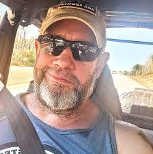 What are some recommendations for a great black and white tattoo artist in  the C-ville area, specializing in military style and new school tattoos?