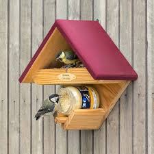 Tall narrow bird house painted in blue, orange and green to appear like a post. Cumberland Bird Feeder Plum Cj Wildlife