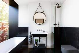 The tiles are cut into elongated rectangles and laid in a herringbone pattern for added style. Black And White Bathroom Designs That Show Simple Can Also Be Interesting
