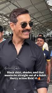 John Abraham spotted at Delhi Airport giving pure Rohit Shetty cop vibes 🔥  Black shirt, shades, and that mustache power packed look! 🚔💥,  @thejohnabraham, ., ., ., ., ., ., ., ., ., ., ., ., ...