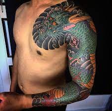 Fire themed dragon tattoo sleeve. 100 Dragon Sleeve Tattoo Designs For Men Fire Breathing Ink Ideas