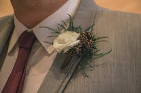 At a winter wedding you can definitely get away with wearing a little branch of evergreen and a pine cone on your tuxedo lapel. Evergreens And Pine Cones Winter Floral Nicole And Derek