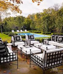Chic Patio Features Wrought Iron Sofas Chairs And Ottomans Covered In Black And White Cushions In 2020 White Patio Furniture Wrought Iron Patio Furniture Patio Decor