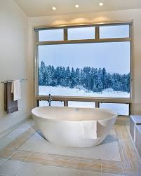 Freestanding tub offers a good soaking spot surrounded by tiles walls and white ceiling. Hot Bathroom Trends Freestanding Bathtubs Bring Home The Spa Retreat