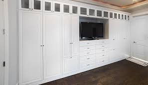 Drawers for folded items, hangers for dresses and suits, and boxes for odds and ends. Custom Wall Unit Storage For The Bedroom