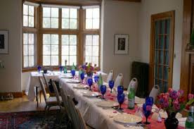 Setup the bar opposite from where guests enter the room or, if there are entry/exits on each end of the party area, set the bar up along the wall in the center of the room. Living Room With Dinner Party Set Up For 20