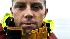 Orange flare aids helicopter pilot in coastal rescue