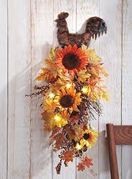 A bold arrangement with sunflowers, a pumpkin and berries. Just Love This Rooster And Sunflower Kitchen Decor For A Country Theme Fall Floral Decor Sunflower Kitchen Decor Floral Swag