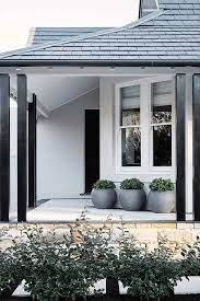 Painting exterior trim fascia boards using a roller and a brush. My Guide To Painting Eaves Making Your Home Beautiful