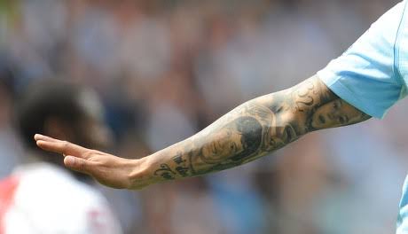 Carlos Tevez tattooed forearm during football match
