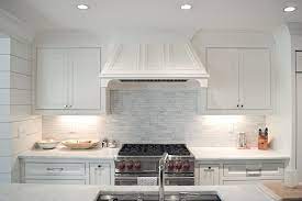 To create the illusion of a small space being bigger, stick to a monochromatic color palette. Linear Marble Tile Backsplash Transitional Kitchen Amanda Orr Architects