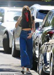 I'm so in live with this cutie pie. Dakota Johnson Flashes Her Midriff In A Dark Crop Top And High Waisted Denim Bell Bottoms Readsector