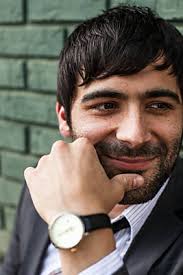A Man With Dark Hair And Beard Smiling And Looking Down" by Stocksy  Contributor "J Danielle Wehunt"