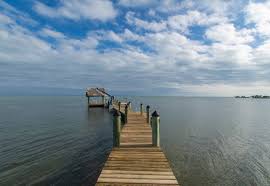 This charming home sits on a large tropical lot (100' dock) with a great tiki and a large hot tub for late afternoon relaxation. Island Villa The Beach House