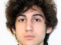 Boston bombing suspect charged in hospital