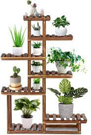 It features a solid wooden frame with metal supports. Amazon Com Tooca Wood Plant Stand Indoor 44 7 Tier Outdoor Tall Plant Stand Flower Stand Multiple Tier Plant Display Rack Holder Steady Vertical Carbonized Shelves For Patio Livingroom Balcony Garden