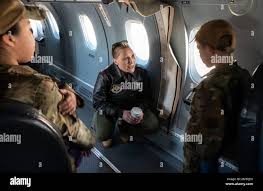 U.S. Air Force Maj. Molly Sexton, a 524th Special Operations Squadron  instructor pilot, discusses the capabilities of the C-146A Wolfhound  aircraft with some of the youth visiting a youth open house event