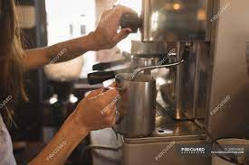 This milk café can warm and froth at the same time as well as make hot chocolate, and you can also froth without warming your liquid of choice. Barista Steaming Milk At The Coffee Machine In A Cafe Preparing Making Stock Photo 209276528