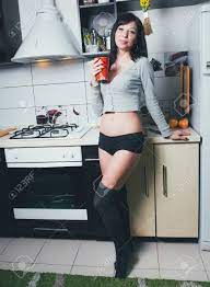 Hot Brunette On The Kitchen. Sexy Young Woman Cooking. Фотография,  картинки, изображения и сток-фотография без роялти. Image 94799159