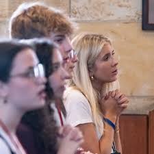 Archbishop Shelton Fabre of Louisville transfers the monstrance to  Archbishop Charles Thompson of Indianapolis during a eucharistic procession  across the Ohio River