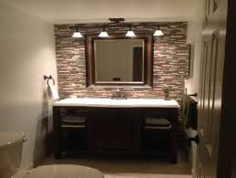 A statement mirror amid patches of mirrors Over Mirror Bathroom Light Fixtures Trendecors