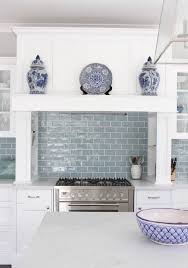 A contemporary kitchen with white upper cabinets and lower grey ones, gold and brass handles plus a white fish scale backsplash. Top Best Blue Grey White Kitchen Design Ideas 3 Kitchen Design Kitchen Renovation White Kitchen Design