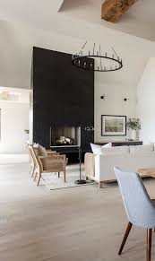 Black And White Modern House Interior Black Modern Farmhouse With Black White Interiors Home Bunch Interior Design Ideas In 2020 White Interior Farmhouse Fireplace Decor Family Living Rooms