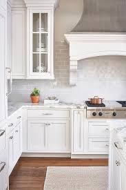 Huge transitional dark wood floor kitchen photo in new york with an undermount sink, shaker cabinets, white cabinets, quartzite countertops, stainless steel appliances. Pin On Fixer Upper
