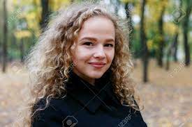 Similar to the black + purple combo, black hair has the ability to make green eyes pop out very effectively, especially on a lighter skin tone. Beautiful Young Woman With Curly Hair Green Eyes Girl In Casual Clothes Relaxing In Park In Good Autumn Weather Covered With Fallen Leaves Stock Photo Picture And Royalty Free Image Image 107066448